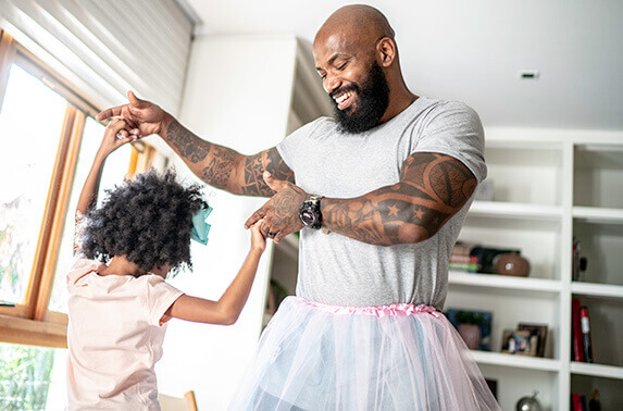 Father playing dress-up with his daughter
