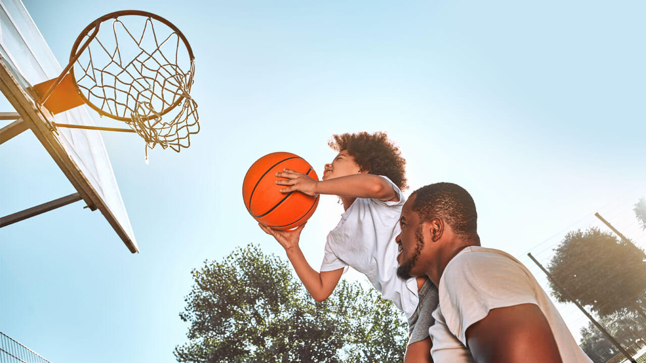 Father and son playing basketball